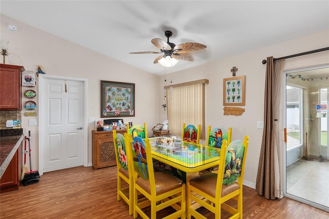 dining room with lofted ceiling, light hardwood / wood-style flooring, and ceiling fan