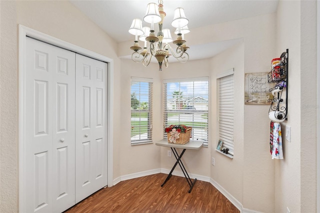 interior space with hardwood / wood-style flooring and a notable chandelier