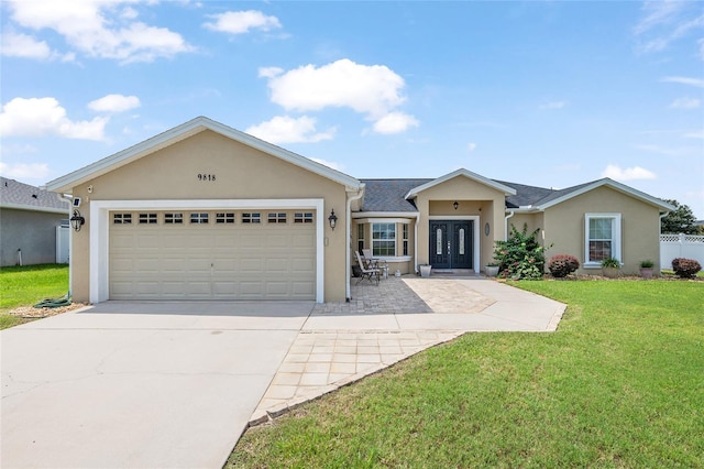 single story home featuring a garage, a front yard, and french doors