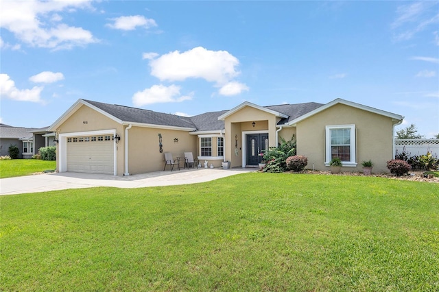 ranch-style house featuring a garage and a front lawn