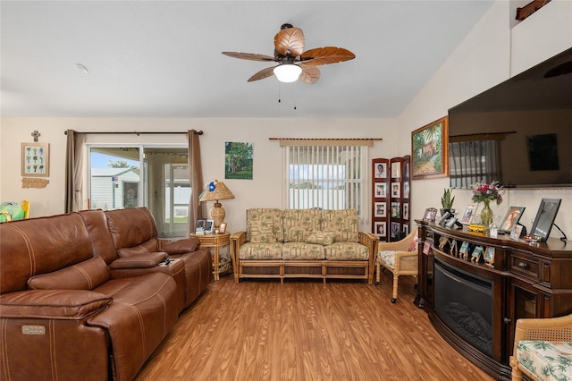 living room featuring ceiling fan, vaulted ceiling, light hardwood / wood-style flooring, and a wealth of natural light