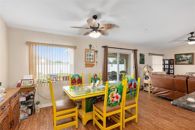 dining space featuring lofted ceiling, light hardwood / wood-style floors, and ceiling fan