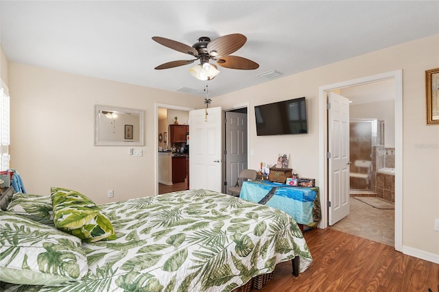 bedroom featuring ensuite bathroom, hardwood / wood-style floors, and ceiling fan