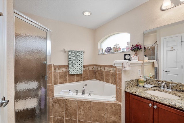 bathroom featuring vanity and separate shower and tub