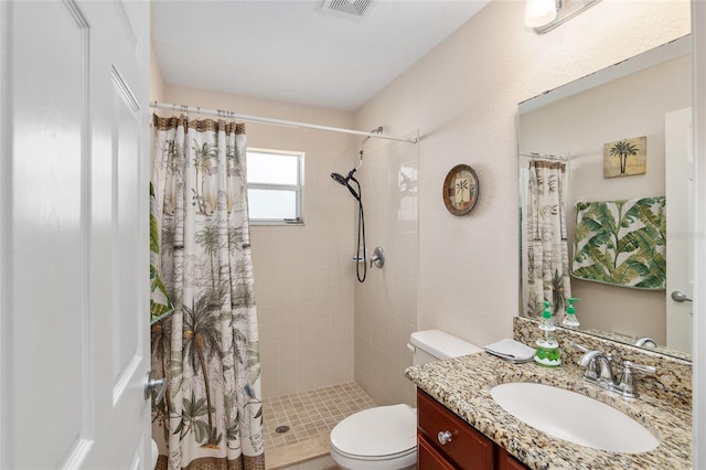 bathroom with vanity, curtained shower, and toilet