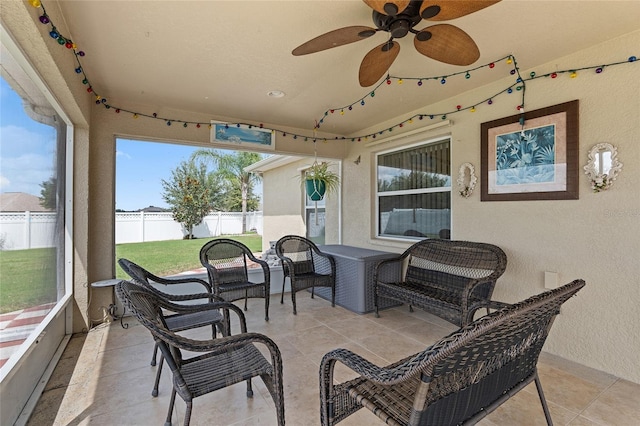 sunroom with ceiling fan