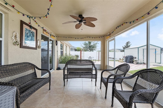 sunroom featuring ceiling fan