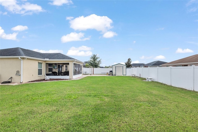 view of yard featuring a sunroom and a storage shed