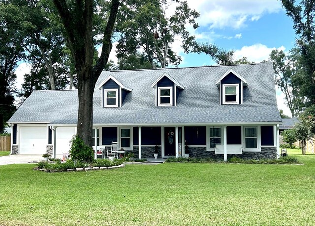 cape cod house featuring a front yard, a garage, and covered porch