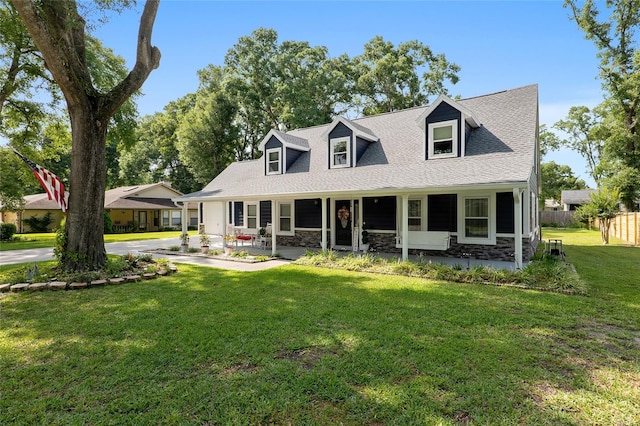 cape cod home with a front yard and covered porch