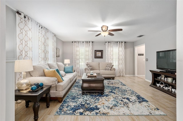 living room featuring light wood-type flooring and ceiling fan