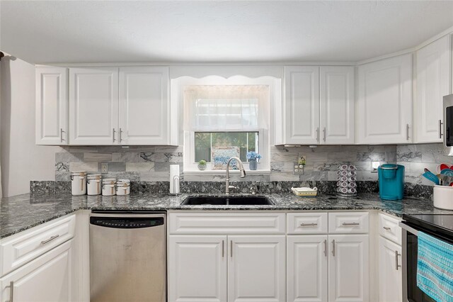 kitchen with stainless steel appliances, white cabinetry, and sink