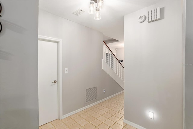 corridor featuring light tile patterned floors