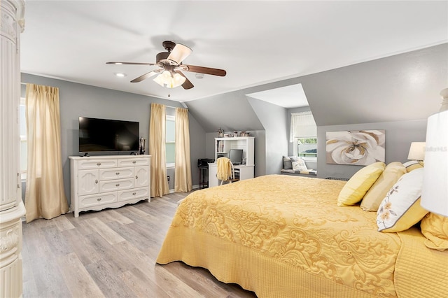 bedroom featuring ceiling fan, light wood-type flooring, and lofted ceiling