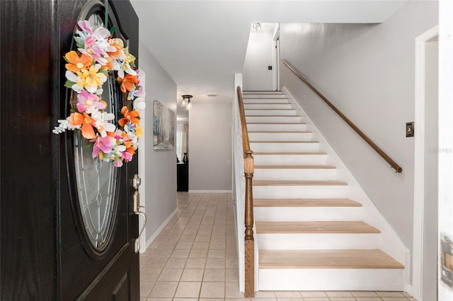 stairway with tile patterned flooring