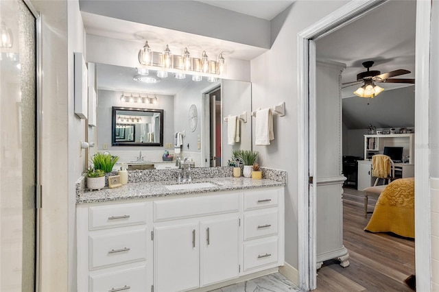 bathroom featuring wood-type flooring, ceiling fan, and vanity