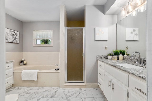 bathroom with vanity and shower with separate bathtub