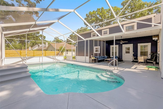 view of swimming pool featuring a lanai, a patio, and ceiling fan