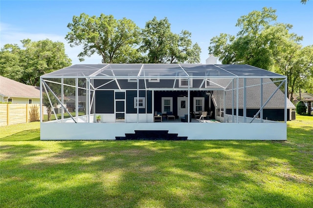 rear view of house featuring a yard, a lanai, and a patio area