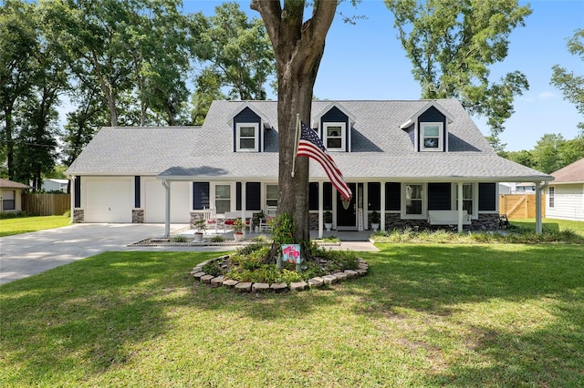 cape cod house with covered porch, a front yard, and a garage