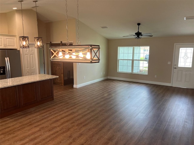 kitchen featuring ceiling fan, pendant lighting, vaulted ceiling, and dark hardwood / wood-style flooring