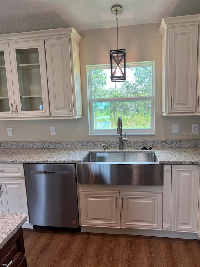 kitchen featuring white cabinets, dishwasher, and decorative light fixtures