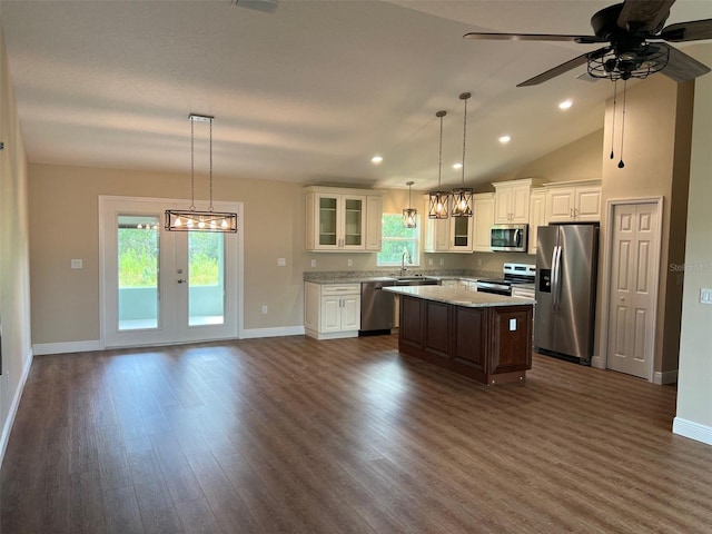 kitchen featuring ceiling fan, appliances with stainless steel finishes, plenty of natural light, and a kitchen island