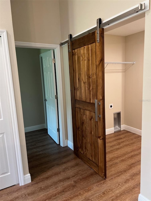 interior space featuring a barn door and dark hardwood / wood-style flooring