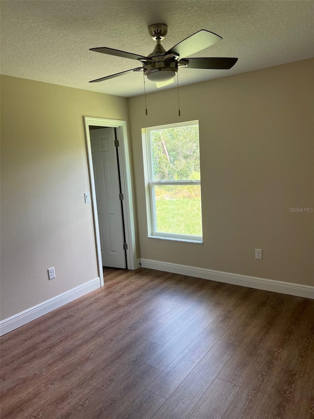 unfurnished room with ceiling fan, a textured ceiling, and hardwood / wood-style floors