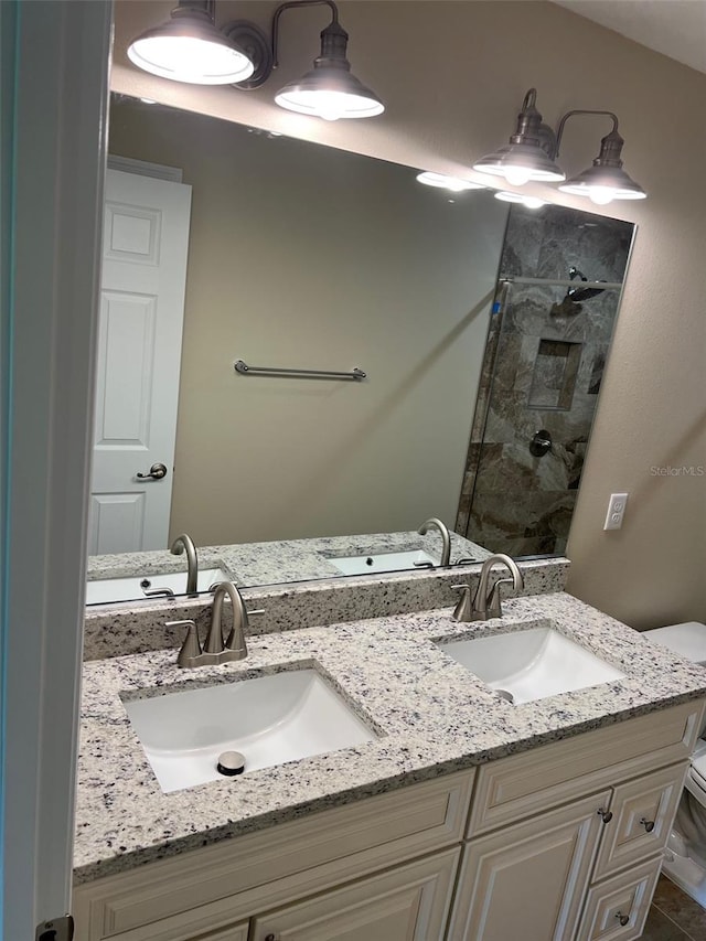 bathroom with walk in shower, vanity, and toilet