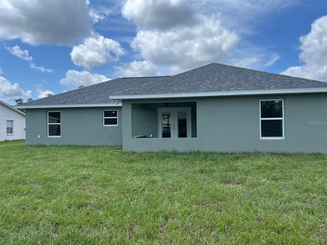 back of house with a lawn