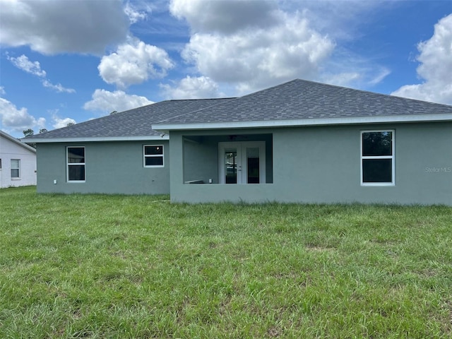 rear view of property featuring a yard