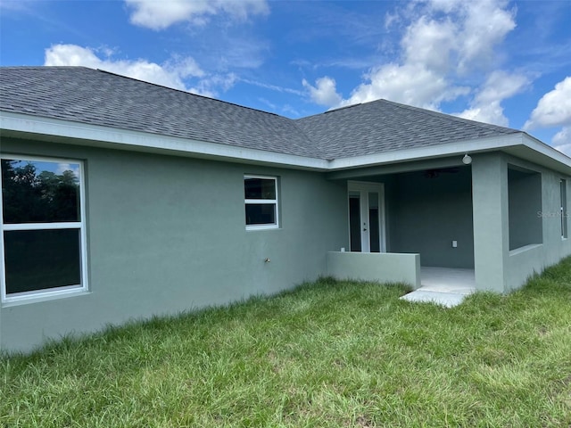 rear view of property with a yard