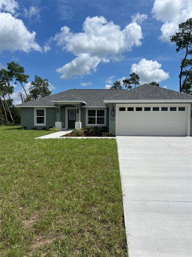 ranch-style house featuring a garage and a front yard