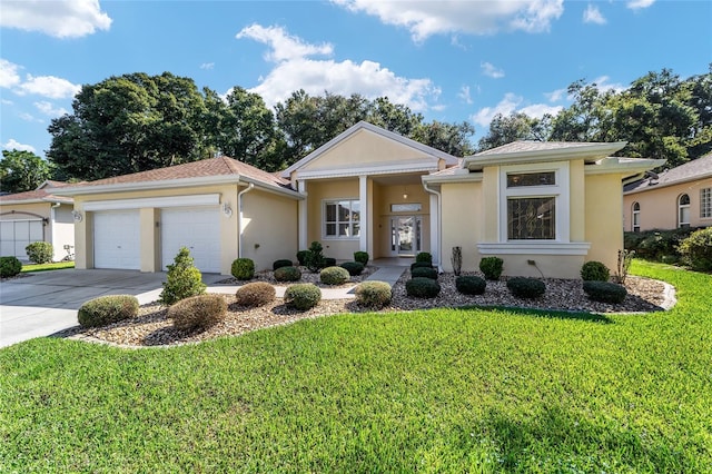 view of front facade with a garage and a front lawn