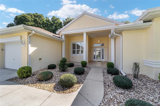 view of exterior entry with a garage