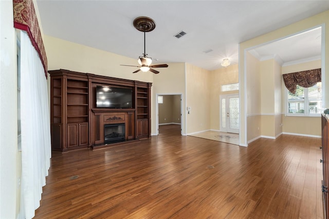 unfurnished living room with ornamental molding, dark hardwood / wood-style floors, and ceiling fan