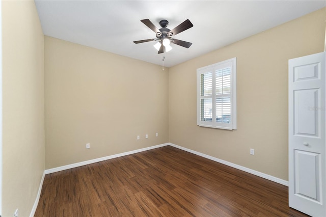 empty room featuring ceiling fan and dark hardwood / wood-style flooring