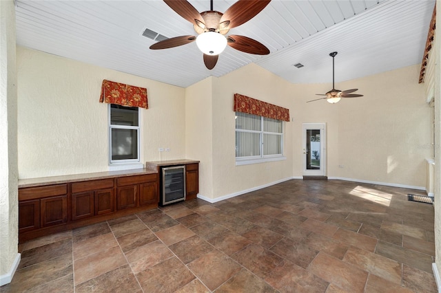 unfurnished living room with beverage cooler, ceiling fan, and wooden ceiling