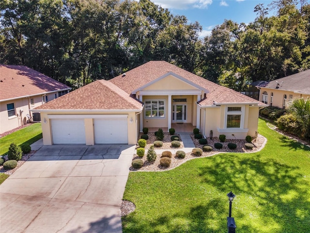 view of front of house with a front lawn and a garage