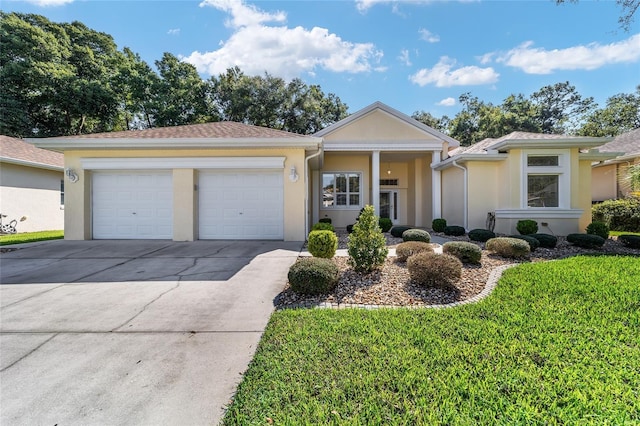 single story home featuring a garage and a front lawn