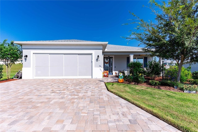 view of front of home featuring a front lawn and a garage