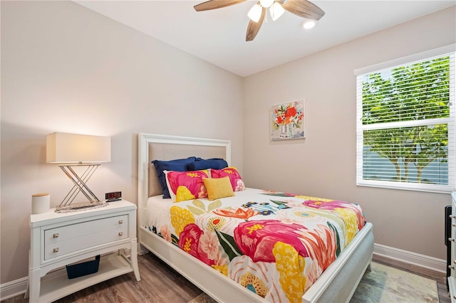 bedroom with dark wood-type flooring and ceiling fan