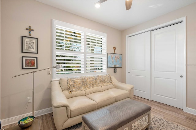 sitting room featuring ceiling fan and light wood-type flooring