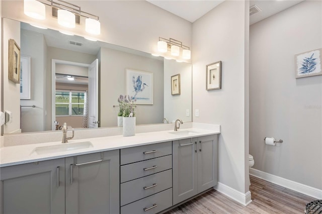 bathroom featuring hardwood / wood-style flooring, vanity, and toilet