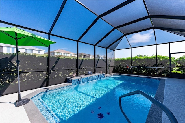 view of swimming pool featuring pool water feature and a lanai