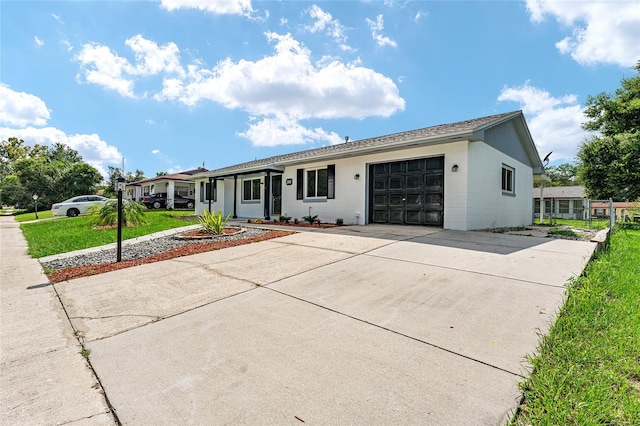 single story home with a garage and a front lawn