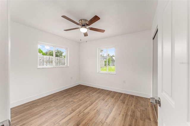 unfurnished bedroom with light hardwood / wood-style flooring, multiple windows, and ceiling fan