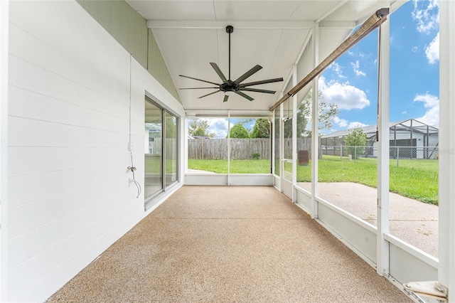 unfurnished sunroom with vaulted ceiling and ceiling fan