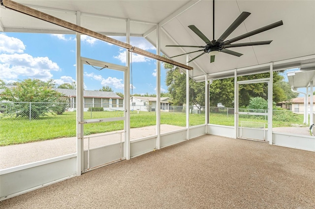 unfurnished sunroom featuring lofted ceiling and ceiling fan